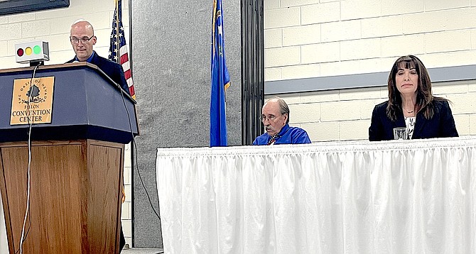 Incumbent Judge Ben Trotter, left, answers a question at Candidates Night while Stuart Richardson, center, and Brenda Ingram wait to speak.