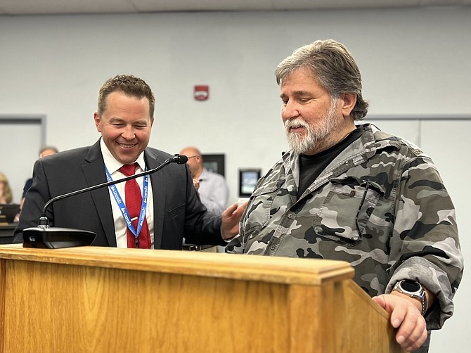 Superintendent Andrew Feuling congratulates Carson City bus driver Jeff White, retiring from the school district this year, for 22 years of service. Forty-one district employees were honored for their service during the May 28 Carson City School Board meeting.