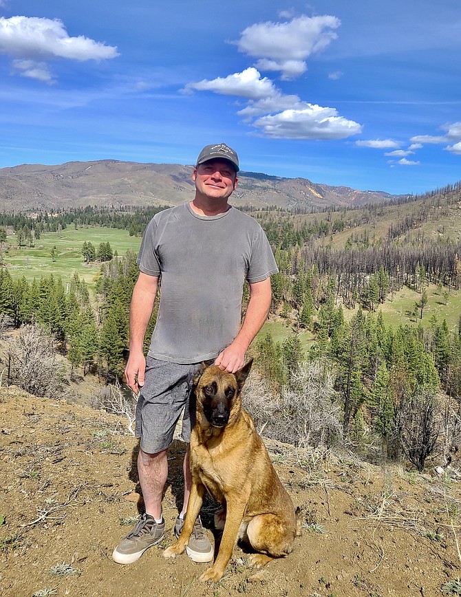 Michael Hyllested with his Belgian Malinois, “Star Lord” in the hills above the tiny town of Markleeville.