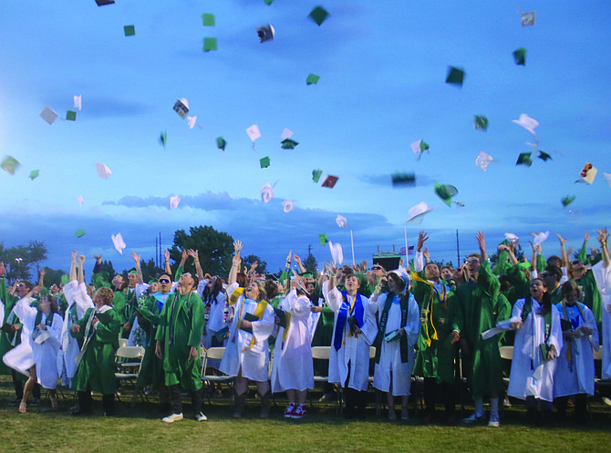 Seniors throw their caps into the air at the Churchill County High School commencement exercise.