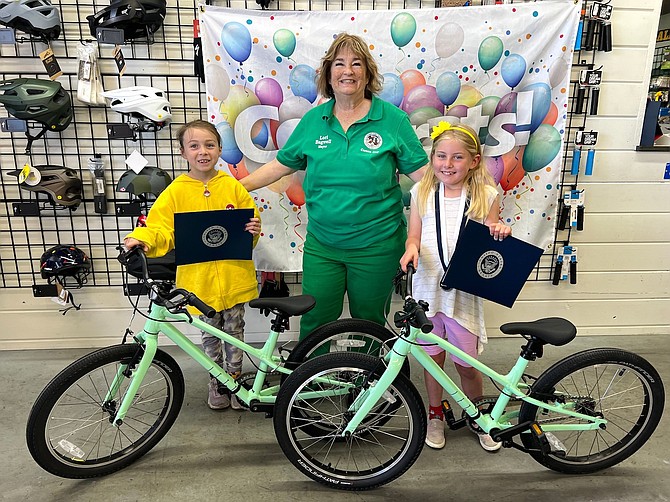 Alizabeth Galloway, a first grader at Mark Twain Elementary School, far left, and Avery Smith, a second grader at Bordewich Bray Elementary School, pose with Mayor Lori Bagwell with their bicycles and certificates they received as prizes for achieving perfect attendance.