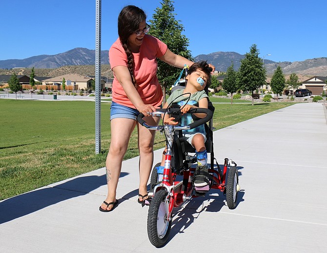 Melinda Felix of Carson City is the mother of 4-year-old Brendan Felix, who was diagnosed with a rare blood vessel abnormality called a vein of Galen malformation in his brain two days after he was born in March 2020. He also has been diagnosed with cerebral palsy, hydrocephalus, epilepsy and cortical blindness. Felix walks with her son at Schulz Ranch Park on June 7 to keep his body as active as possible.