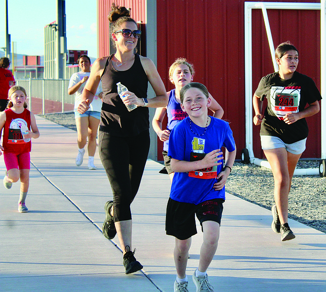 Masey Brooks, Kelly Brooks, Josie Brooks, Elle Houston and Kelsey Collins take off from Joe Yanni Field in the Mustang 5K.