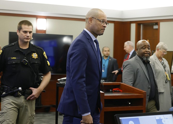 Nevada Attorney General Aaron Ford enters the courtroom where Nevada Republicans accused in a fake elector scheme are being arraigned at the Regional Justice Center on Dec. 18, 2023, in Las Vegas.