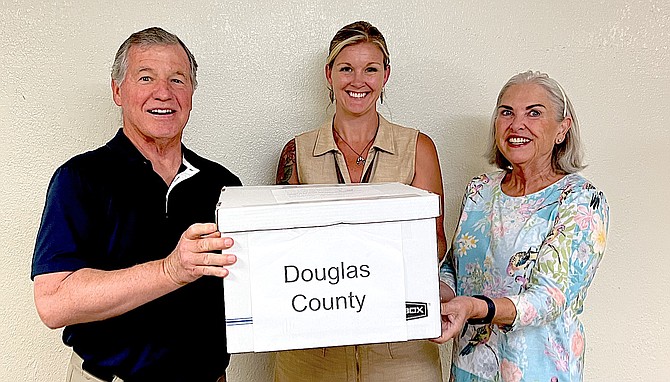 Douglas County Republican Central Committee members Jon Crawford and Linda Houchin flank Clerk-Treasurer Amy Burgans on Monday.