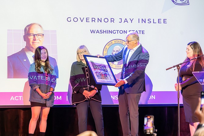 Grace Yoo, Executive Director of WSWC (left), and Quinn Dalan, Commission Chair of WSWC (right), honor Trudi Inslee and Governor Jay Inslee for their work advancing gender equity in Washington State.