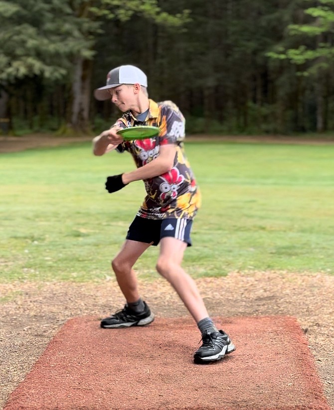 JoJo Neibauer, 13, readies to throw a disc during a practice round.