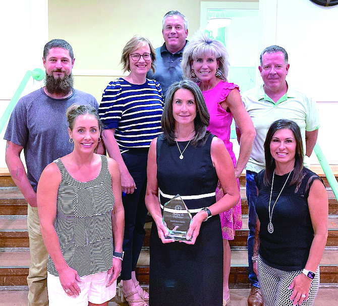 Trustees honor retiring Trustee Tricia Strasdin for her service to the school board. Front row, from left: Julie Guerrero-Goetsch, Strasdin and Wendy Bullock. Middle row, from left: Joe McFadden, Kathryn Whitaker, Amber Getto and Gregg Malkovich. In the back is Matt Hyde.