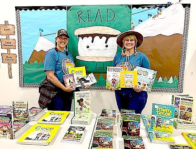 Meneley Elementary School Reading Interventionist Lisa LaRocque and Learning Strategist Noelle Menicucci hold books purchased by the Tahoe Douglas Elks. Photo special to The R-C by Dave Stewart