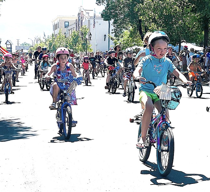 Tykes ride their bikes on Esmeralda Avenue as part of the annual Minden Town Barbecue in Minden Park.