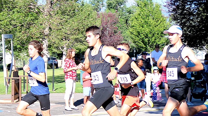 Freedom 5K second-place winner Imanol Pereda takes an early lead with first-place winner Ayden Mosby catching up followed by Cayden Mosby.