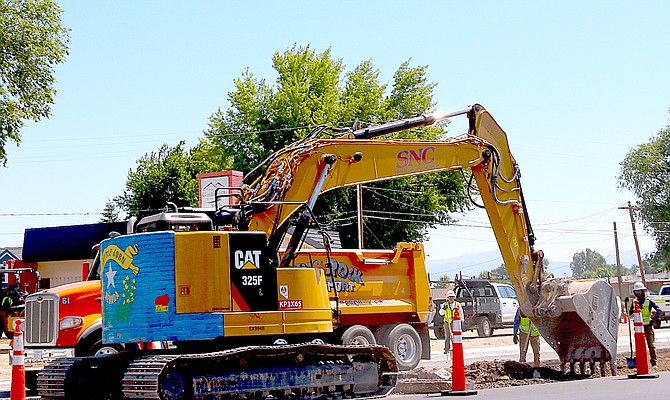 An excavator digs up the S-Curve on Highway 395 in Gardnerville on Monday.