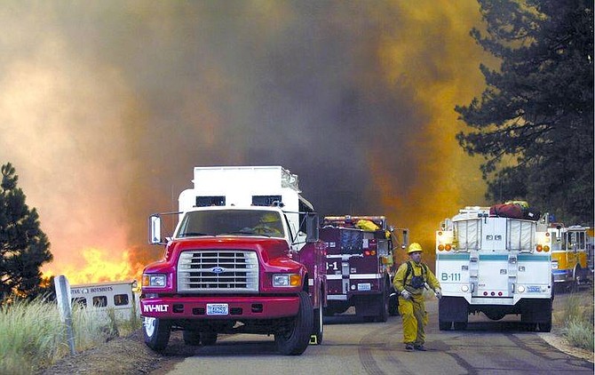 Fire crews scramble to get out of Kings Canyon after the Waterfall Fire took off July 14, 2004, destroying several fire trucks and injuring two people.