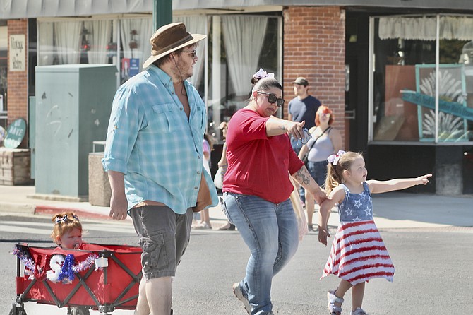 A Lovelock family proceeds down Main Street to courthouse park.