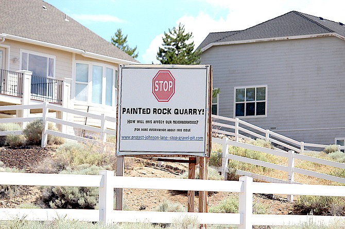 A sign along Johnson Lane protests the Painted Rock gravel quarry on Monday.