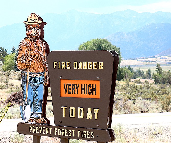 Dark clouds arrive over the Carson Range as Smoky Bear cautions folks driving through Alpine View about the fire danger.