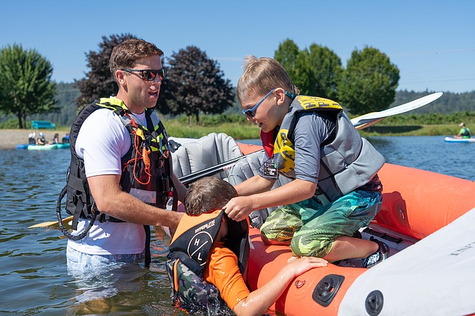 Children learn multiple skills, such as pulling a buddy out of the water onto a vessel, as seen above, during a water safety class put on by Snohomish Regional Fire and Rescue held Tuesday, July 9 at Monroe’s Lake Tye.