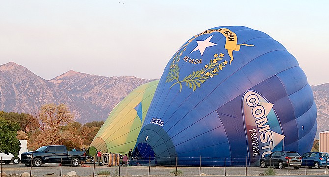 The rising sun shines off a balloon being inflated south of Gardnerville on Wednesday morning.