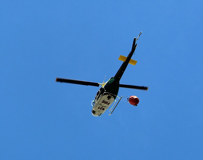 A Nevada Division of Forestry helicopter flies over Genoa during the 2022 Cemetery Fire.