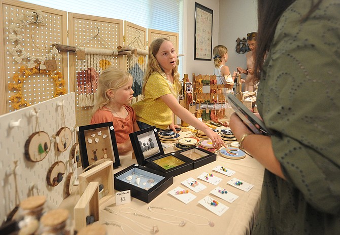 Twelve-year-old Clara explains how she, along with her eight-year-old sister Tessa, made some of the handcrafted items that they were vending at last week’s Snohomish Chamber of Commerce meeting. A parent declined to provide their last name.