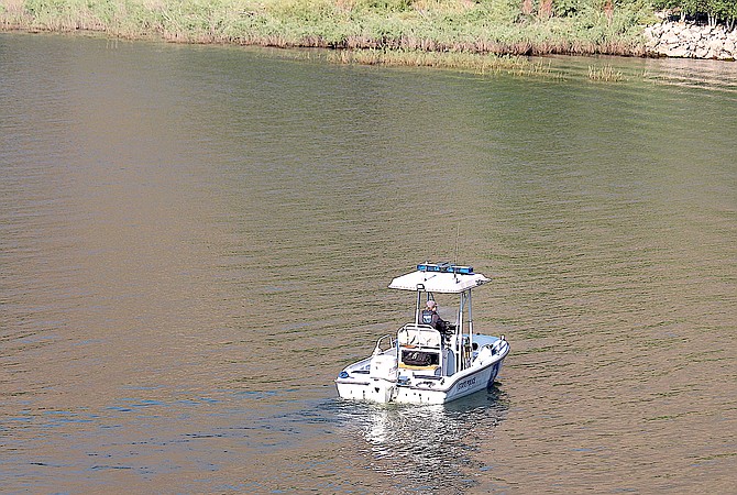 A Nevada State Police boat patrols the shore of Topaz Lake on Monday morning.