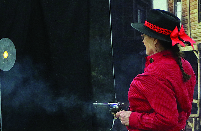 Crystal J fires her pistol at Rafter 3C Arena in Fallon during the 2023 The Fastest Gun Alive — World Championship of Cowboy Fast Draw.