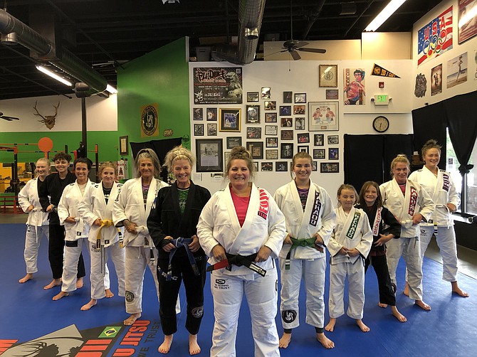 Shelbie Fujii, front middle, poses for a photo with a class at her Brazilian jiu jitsu school in Gardnerville. Fujii became one of the Carson Valley’s first female BJJ black belts.