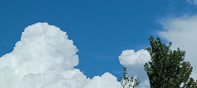 Gardnerville reesident Roger Brekas sees a giant and a fist in this cloud formation from Tuesday afternoon. The Pine Nuts bore the punch of Tuesday's weather, but it might be Carson Valley's turn today.