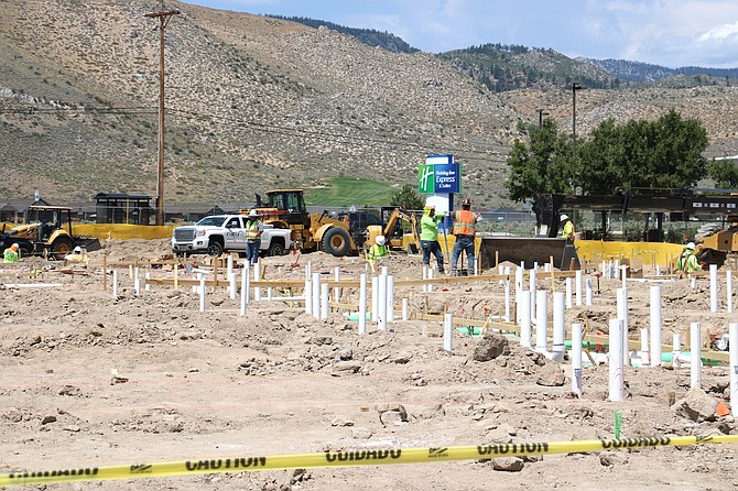 Workers on the site of the new Home2 Suites by Hilton in north Carson on July 24. Construction of the hotel is expected to wrap up by fall 2025.