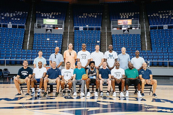 The 2003-04 Nevada men’s basketball team poses to recreate an old photo Wednesday at Lawlor Events Center. Seated (L-R): student assistant Matt Ochs, Garry Hill-Thomas, Seth Taylor, Kyle Shiloh, Todd Okeson, Marcelus Kemp, Curry Lynch, Jermaine Washington, Kirk Snyder, strength and conditioning coach Matt Eck. Standing (L-R): assistant coach Josh Newman, head coach Trent Johnson, Nick Fazekas, Chad Bell, Sean Paul, Kevinn Pinkney, assistant head coach Mark Fox, assistant coach David Carter.