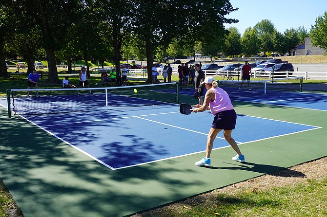 Nathan Goodell and Sheryl Nelson (foreground) play a friendly game against Joy Petrick and Jack Freelander, all residents of Monroe, after the grand opening of two new pickleball courts at Sky River Park Tuesday, July 23.