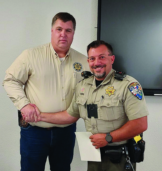 Sheriff Richard Hickox, left, recently recognized Deputy Michael Hardin for his swift action during a medical emergency.