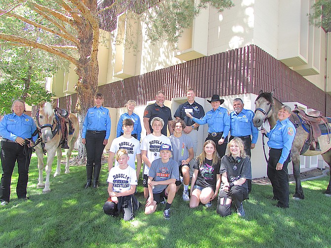 The Douglas County Sheriff’s Office Mounted Posse donated $1,000 to the Carson Valley Wrestling team on Friday.