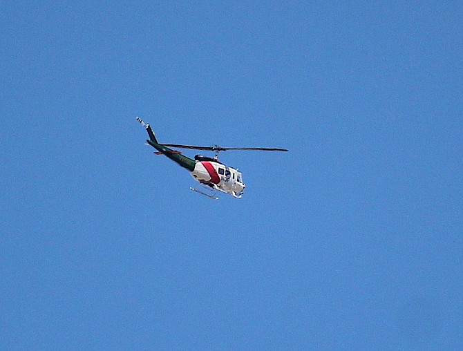 A Nevada Division of Forestry helicopter flies over Minden as part of a training mission on Monday afternoon.