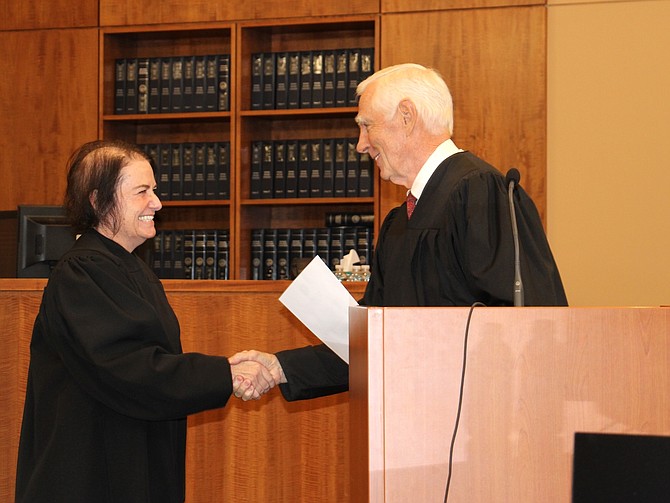 Newest Carson City Justice of the Peace Melanie Bruketta shaking Judge James Russell’s hand during a swearing-in ceremony Aug. 2, 2024.