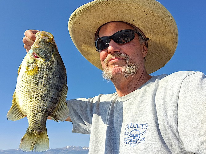 Doug Busey with a perch that he caught in Bridgeport Reservoir and ate.