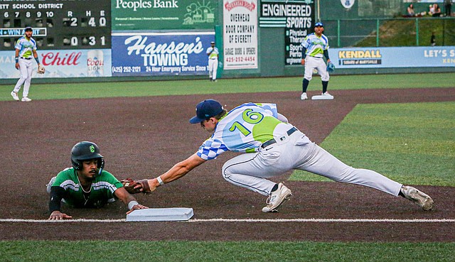 AquaSox third baseman Caleb Cali tags Eugene Emeralds runner Sabin Ceballos in early inning action of the Saturday, Aug. 3 game between the two teams in the Northwest League. 
The Eugene Emeralds beat the hometown Sox, under the lights, 4 - 2 on 8 hits and no errors. The Sox could not convert on 6 hits and suffered 2 errors.  
Emeralds pitcher Tyler Vogel had a 3.0 Earned Run Average. Sox pitcher Shaddon Peavyhouse had a 2.7 Earned Run Average.
	The series of six AquaSox versus Emeralds games went:
	July 30: Everett won 3-2	
	July 31: Eugene won 16-9	
	Aug. 1: Everett won 13-11	
	Aug. 2: Everett won 11-7 
	Aug. 3: Eugene won 4-2
	Aug. 4: Eugene won 5-4
 Everett this week is on the road playing the Hillsboro Hops near Portland, Oregon.