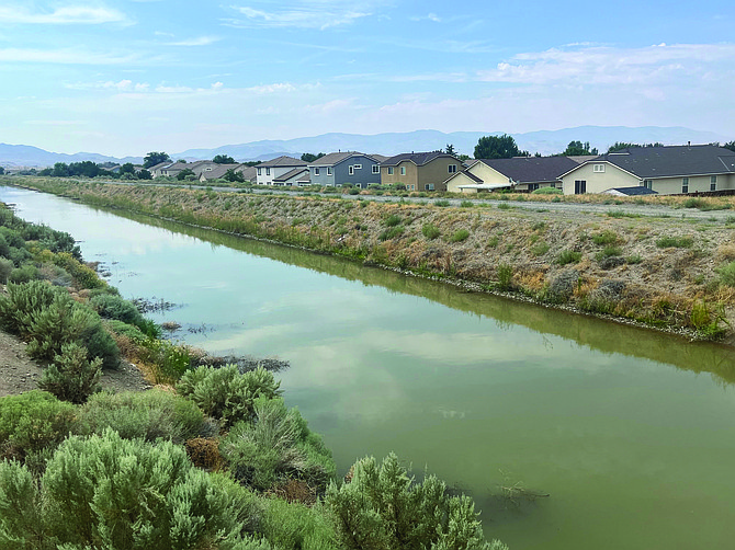 The Truckee Canal flows behind a housing subdivision last week on its way to Lahontan Reservoir.