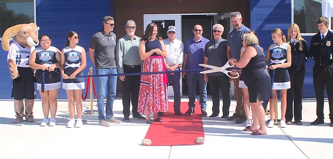 Rochelle Tisdale, Oasis Academy’s high school principal, prepares to cut the ribbon on July 30, marking the completion of the grades 9-12 building.