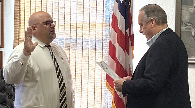 Mayor Ken Tedford, right, swears in Michael O’Neill as the city clerk/treasurer during a special meeting Aug. 9.