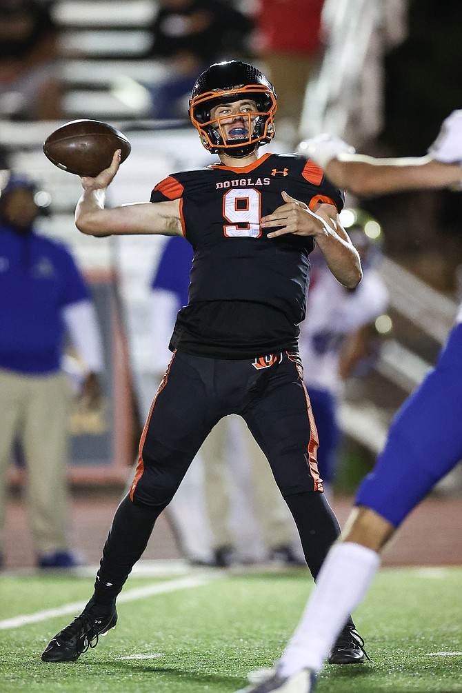 Douglas High quarterback Jackson Ovard winds up to throw against Reed last fall. Ovard will be back under center for the Tigers this season as a senior and team captain.