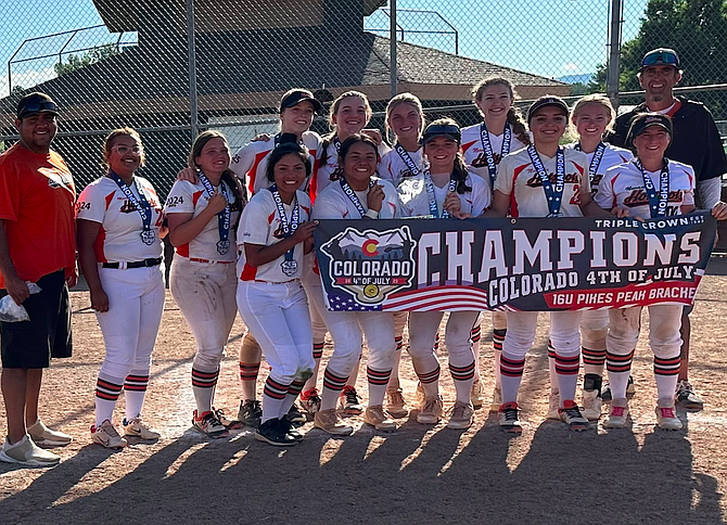 The Nevada Hot Shots 16U team poses with a championship banner at a Colorado tournament, during the summer. The travel softball program features chances for players to play all over the west coast in front of collegiate scouts.