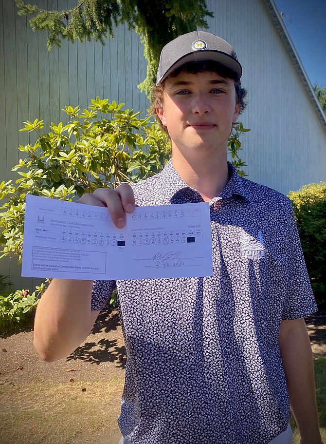 Palmer Mutcheson holds his scorecard from the round of golf Aug. 4.