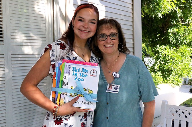 First-year teacher Shea DeJoseph, left, begins her teaching career at Bordewich Bray Elementary School this year with school Principal Cheryl Richetta. DeJoseph holds a set of books, provided by her mentor Michele Cacioppo, for her classroom.