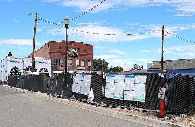 A fence surrounds the empty parcel on Eddy Street that has been used by Sierra Nevada Construction while work on Highway 395 has been underway.