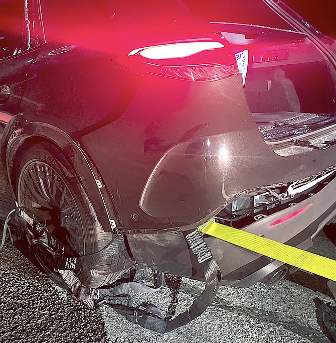 The Grappler Police Bumper System is wrapped around the rear of a Mercedes whose driver is accused of fleeing from officers early Friday morning. Photo by Douglas County Sheriff's Office