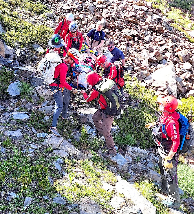 Mono County Search & Rescue team members and medics transport a woman who fell down a steep slope above Mono City on Monday afternoon.