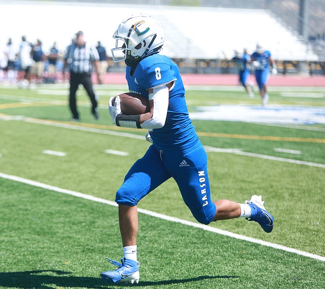 Johnathan Alvarado (8) breaks down the home sideline after recording his second interception of the day for Carson High football against Canyon Springs. Alvarado and the Senators defeated the Pioneers, 27-0, in the first game of the season Saturday afternoon.