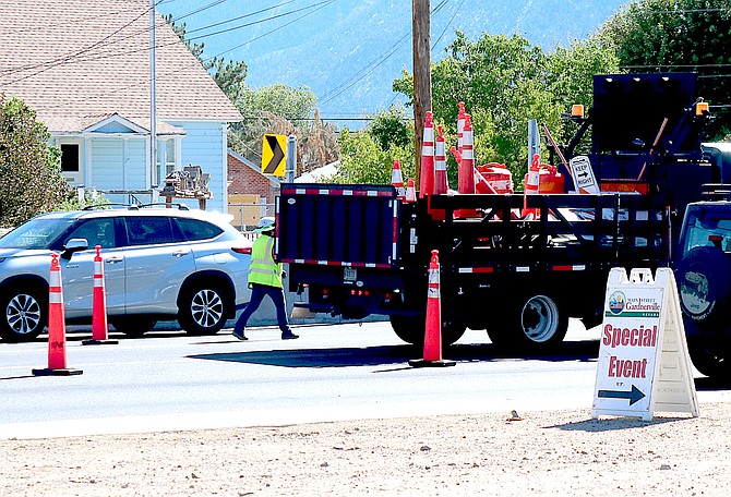 A Sierra Nevada Construction worker adjusts cones in the S Curve near Gardnerville Station on Thursday just as the Main Street Wine Walk was beginning.