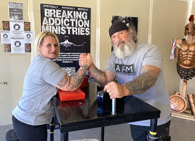 Terry Kilfian, right, and his wife, Tara, pose with their arms locked in their Breaking Addiction Ministries gym. Terry and Tara both medaled at the USA Fit Games in Scottsdale, Arizona in early August.